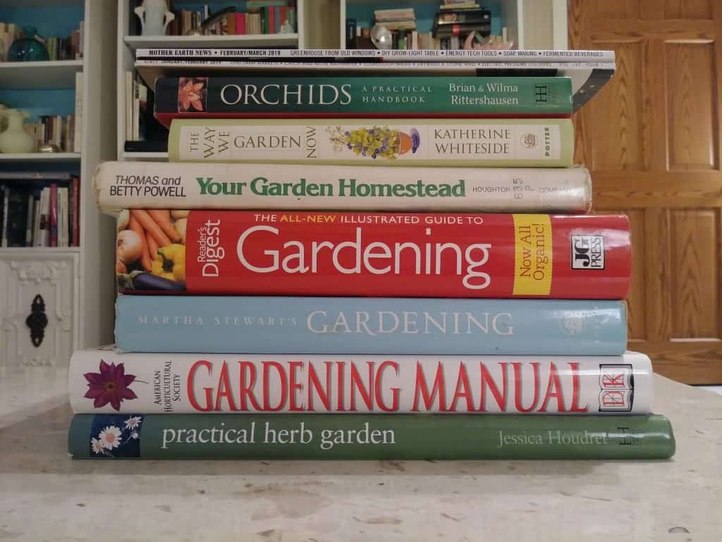 a stack of gardening books