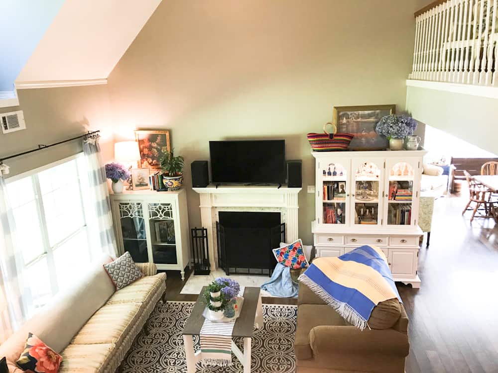 Life Full and Frugal Summer Living Room Makeover, view of living room with lots of colorful accents in the decor, decorative items from Mexico, coffee table, china cabinet, floral throw pillows and Mexican pottery