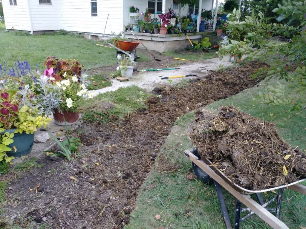 cutting in new flower beds and adding manure life full and frugal