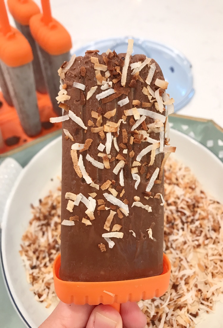 a toasted coconut and chocolate fudgesicle in hand life full and frugal