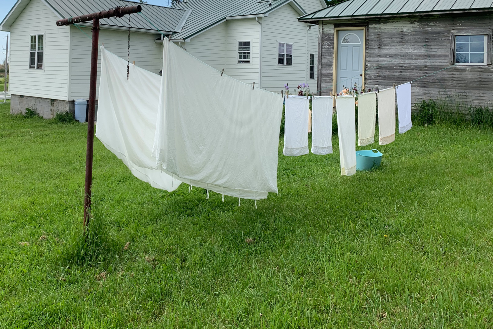 clothes hanging on a clothes line at a house in the country