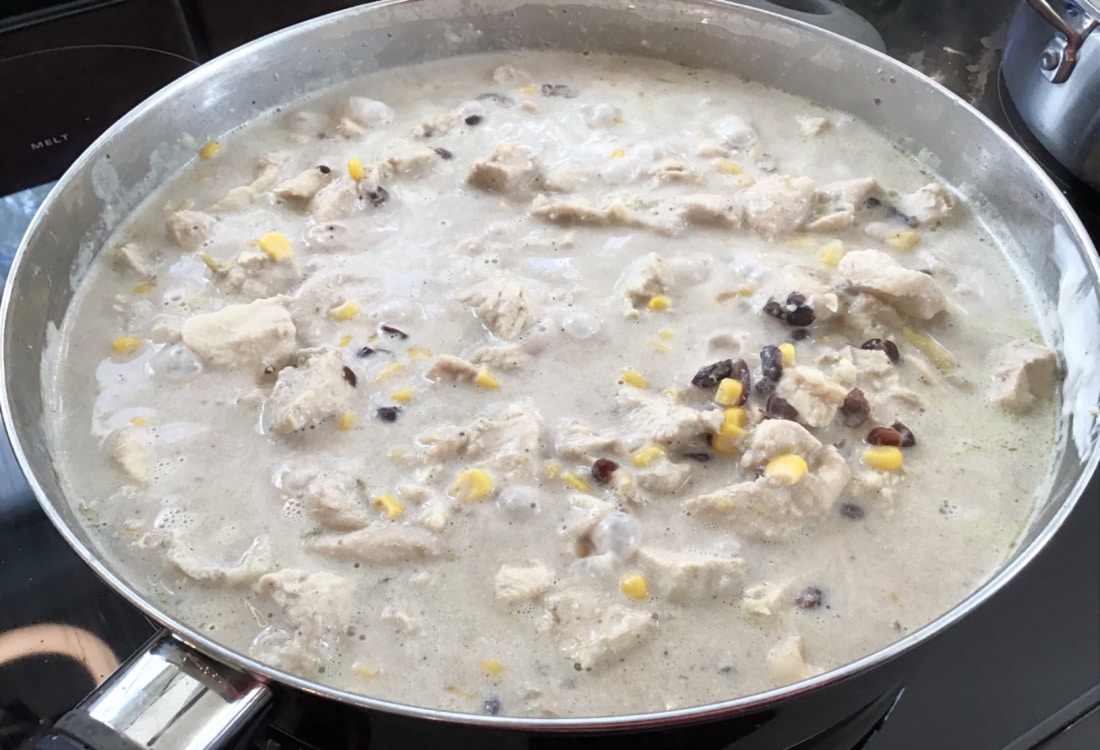 chicken with corn and black beans simmering in a creamy sauce life full and frugal