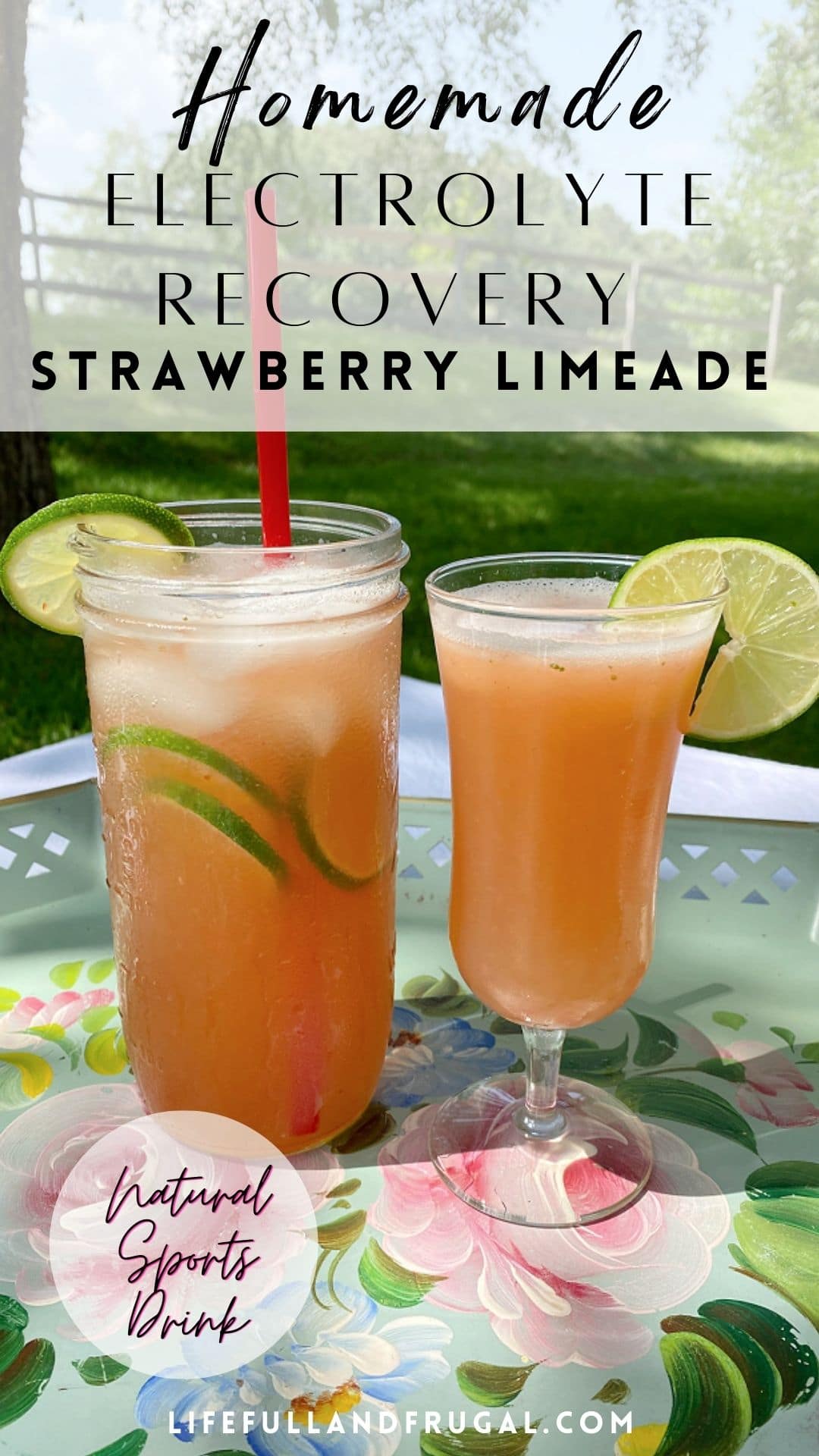 mason jar and a champagne flute with homemade strawberry limeade electrolyte recovery drink garnished with slices of lime sitting on a tray on a picnic table outside - Life Full and Frugal