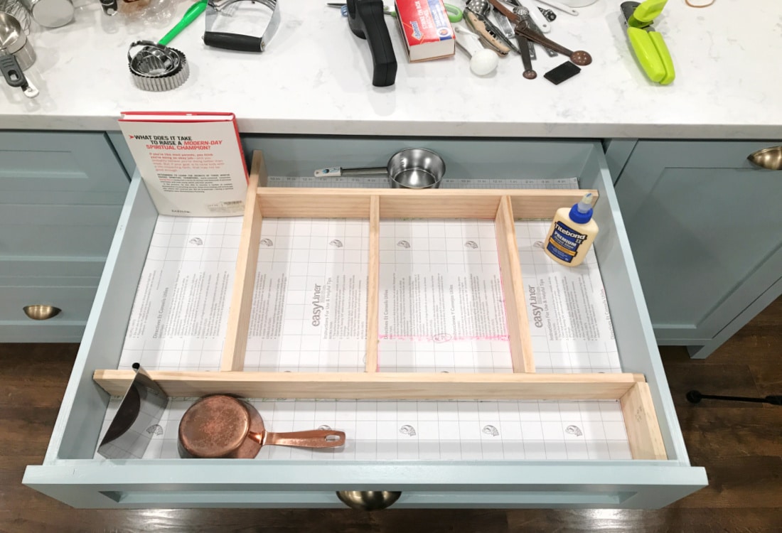 kitchen utensil drawer with craft wood dividers held in place for the glue to dry - Frugal Custom Drawer Dividers - Life Full and Frugal