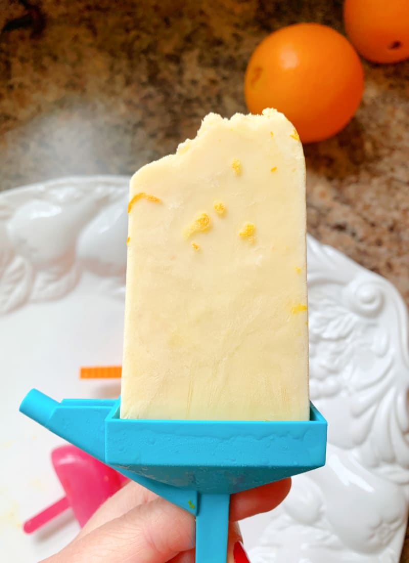 probiotic yogurt dreamsicle popsicle in a mold with a bite taken out of it - Life Full and Frugal